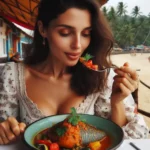 Close-up of Goan fish curry with spices and vegetables.